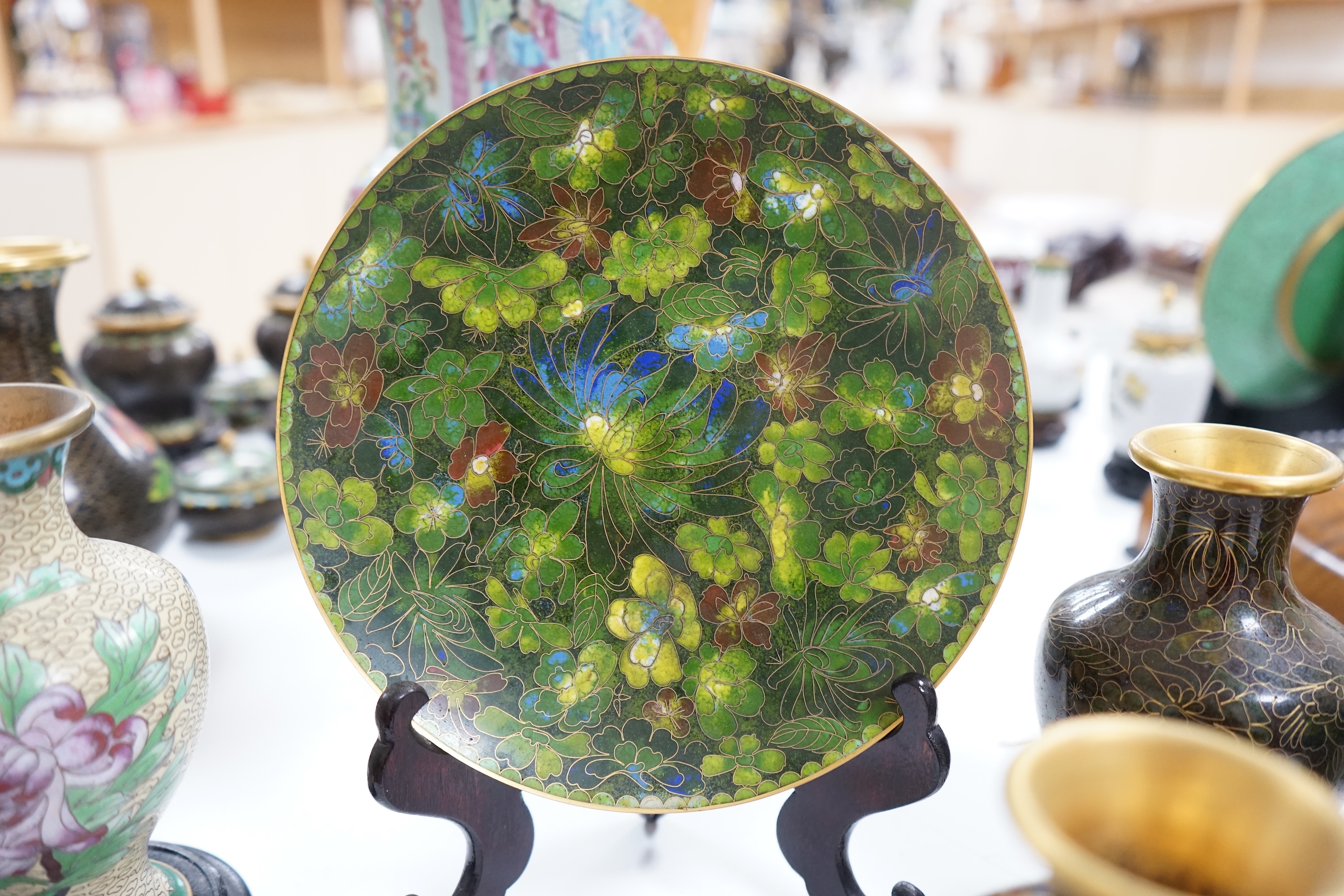 A collection of Chinese cloisonné enamel wares, with mixed coloured backgrounds, all with floral designs, some with stands, plate 21cm diameter. Condition - good